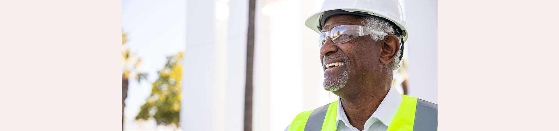 A man wearing safety equipment is smiling.