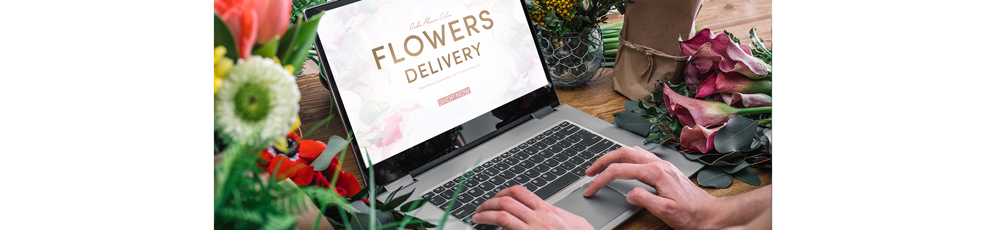 A close-up shot of a person working at a laptop with an open browser that says “Flower delivery.”