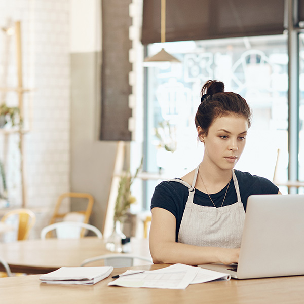 A woman sitting down with a laptop