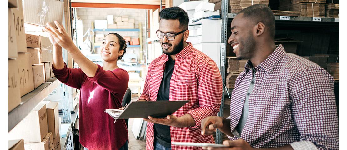 Men and women working together at a diverse small business workplace