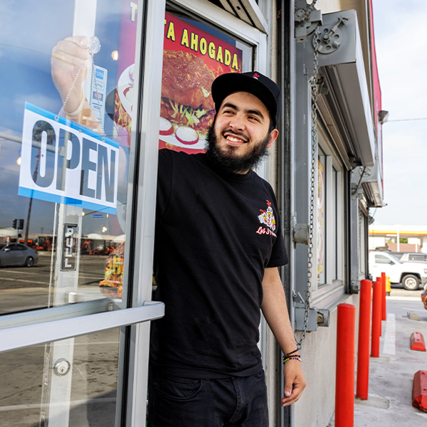 Small diverse business owner opening his restaurant