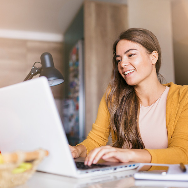 A woman business owner reviews paperwork in an office.