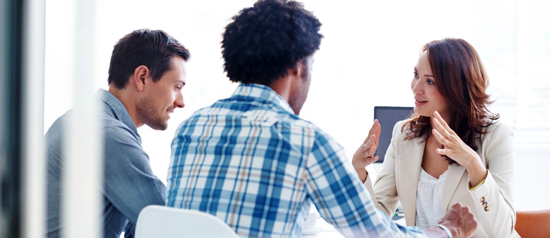 a worker leading a meeting with two other workers