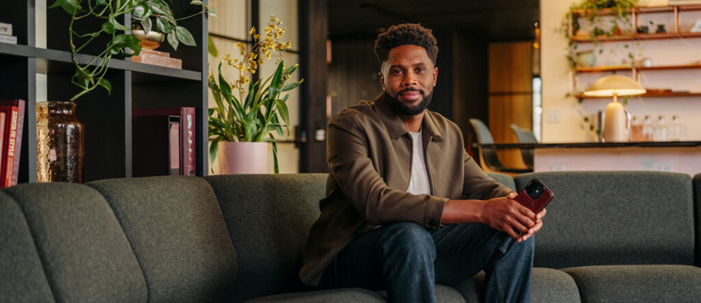 A business man sitting on a couch in his office.