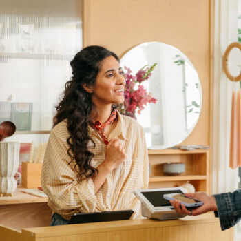 Customer pays with a mobile device at a business checkout counter